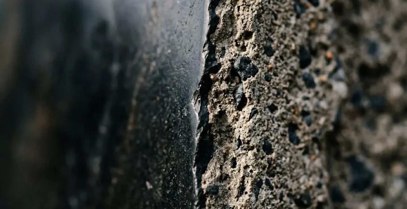 A macro photograph showing a sharp edge, symbolizing the financial cliff-edge of the 60% tax trap at the £100k income threshold.